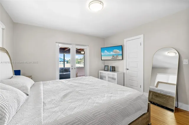 a bedroom with a bed and a television