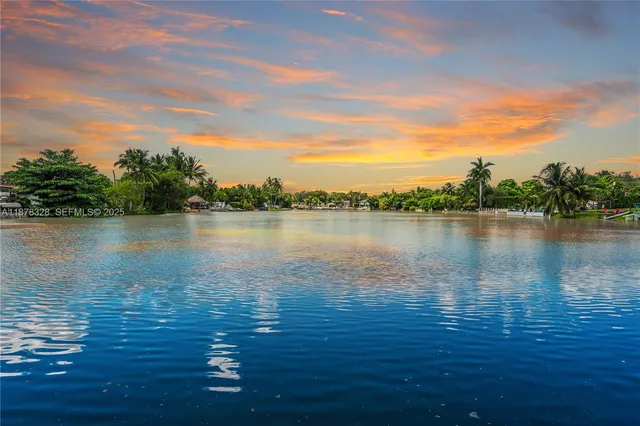 a view of a lake view with houses in back