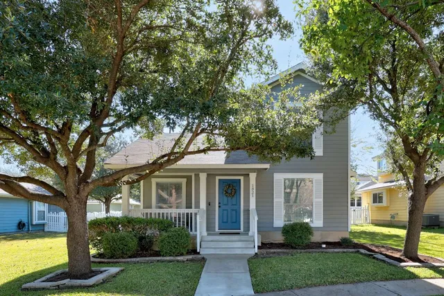 a front view of a house with yard and green space