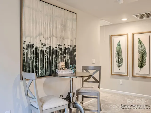 a dining room with furniture and a window