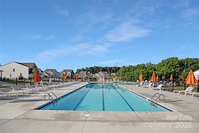 a view of a tennis ground with large trees