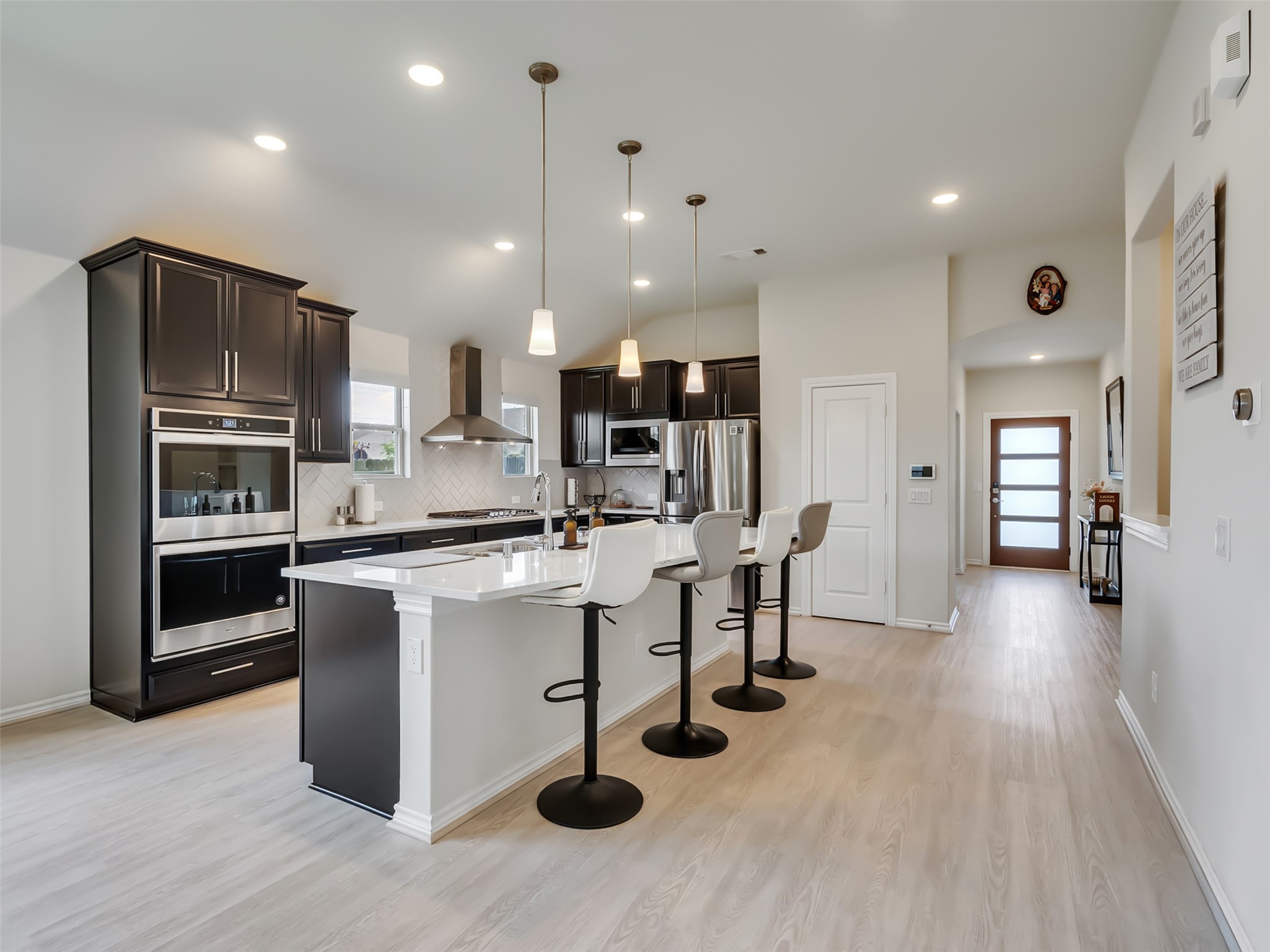 27997 Lone Hollow Lane Spring, TX 77386 - Photo 22 of 45 a kitchen with stainless steel appliances granite countertop a refrigerator a sink dishwasher a stove and white cabinets with wooden floor