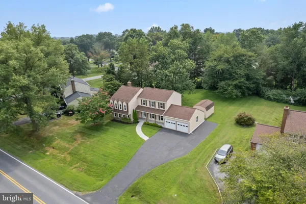 an aerial view of a house with outdoor space swimming pool