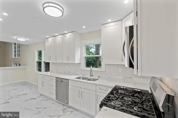 a kitchen with stainless steel appliances a refrigerator and cabinets