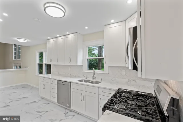 a kitchen with stainless steel appliances a refrigerator and cabinets