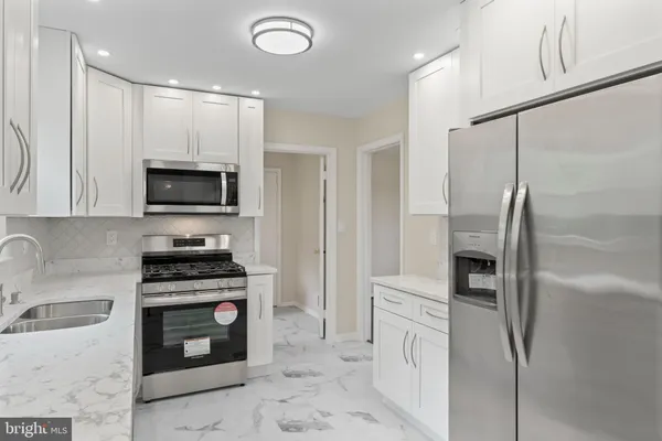 a view of staircase with white walls and windows