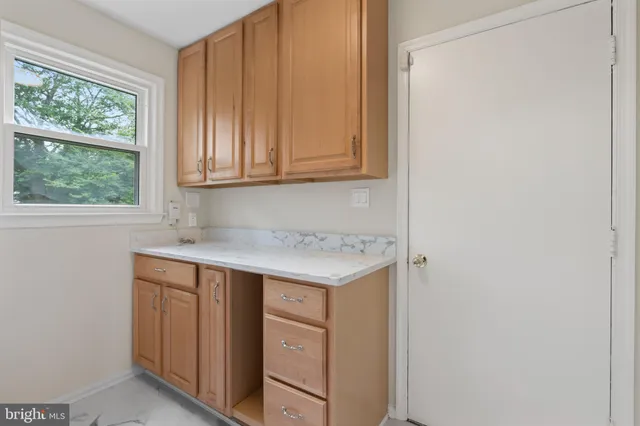 a kitchen with stainless steel appliances a refrigerator sink and microwave