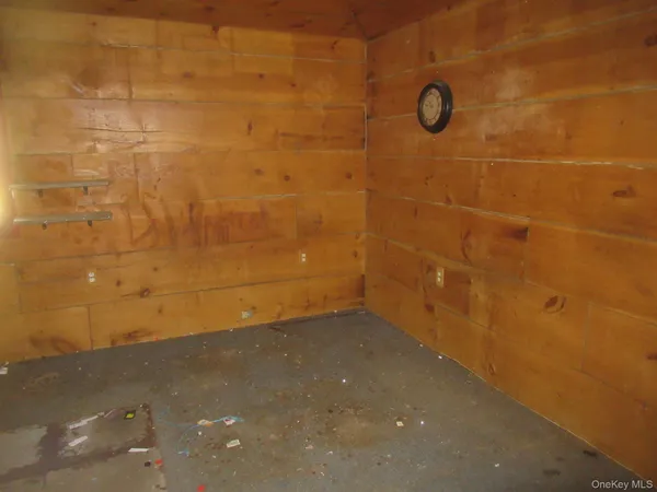 an empty room with closet and a chandelier fan