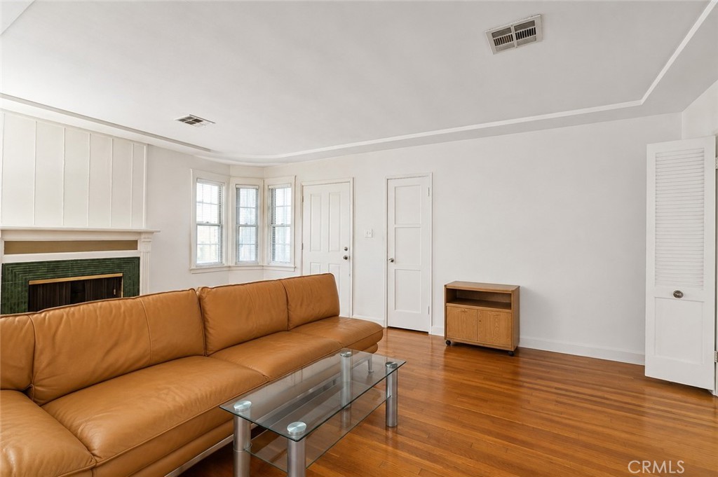 2209 Queensberry Road Pasadena, CA 91104 - Photo 11 of 44 a living room with furniture a fireplace and a wooden floor
