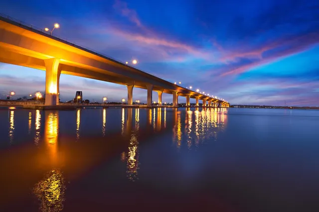 a view of swimming pool with a table and chairs in patio