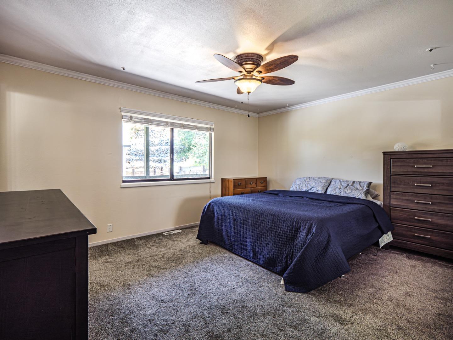 577 Carr Avenue Aromas, CA 95004 - Photo 21 of 37 a spacious bedroom with a bed and a window