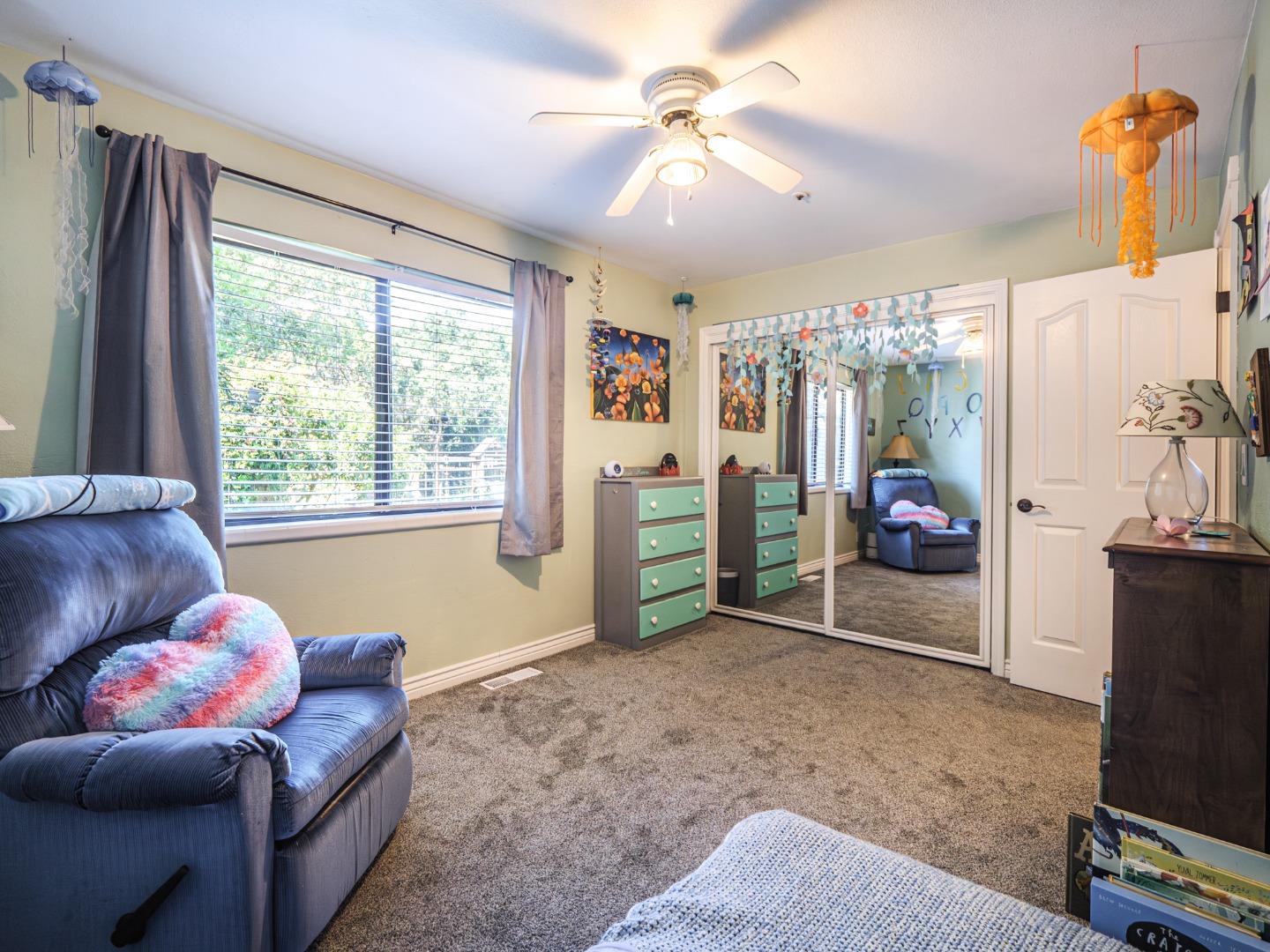 577 Carr Avenue Aromas, CA 95004 - Photo 23 of 37 a living room with furniture a flat screen tv and a large window
