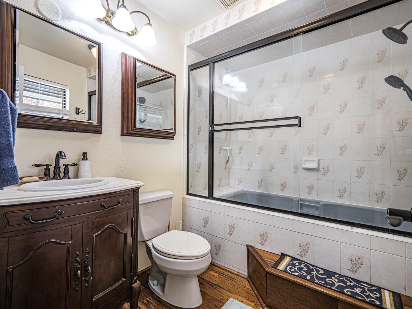577 Carr Avenue Aromas, CA 95004 - Photo 25 of 37 a bathroom with a granite countertop sink a toilet and a mirror