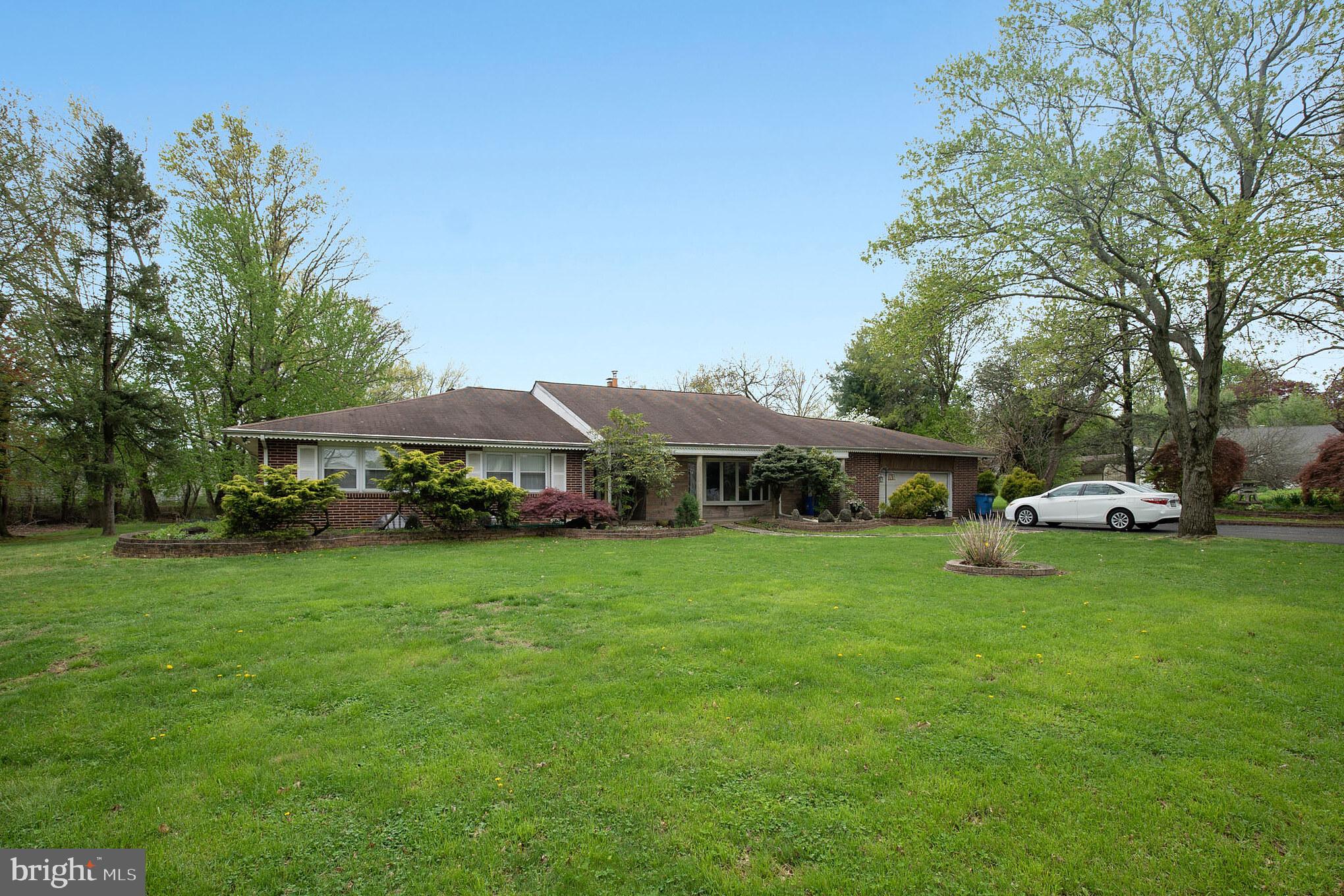 Large front yard with manicured shrubbery