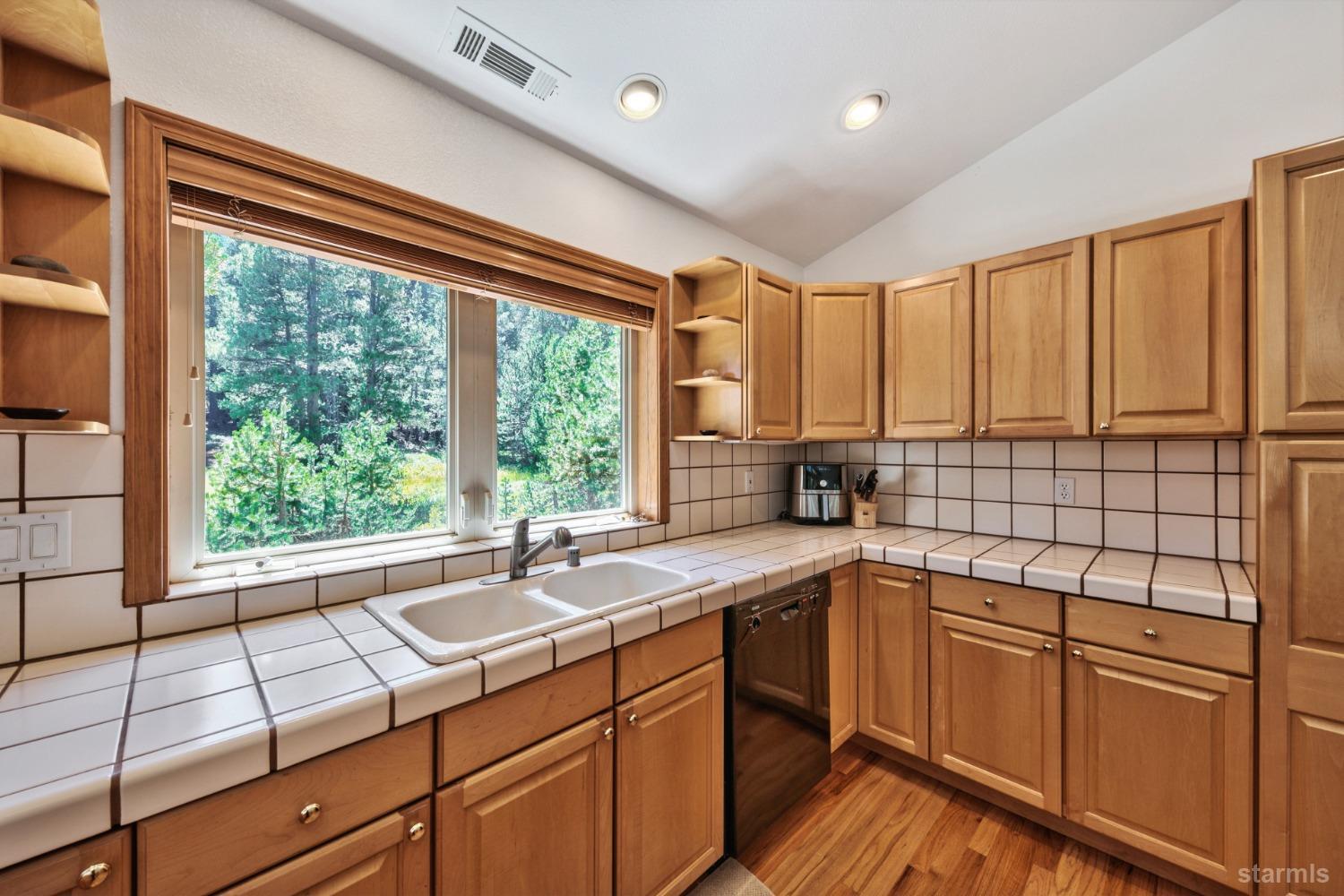 34235 Fremont Road Kirkwood, CA 95646 - Photo 12 of 29 a kitchen with a sink window and cabinets