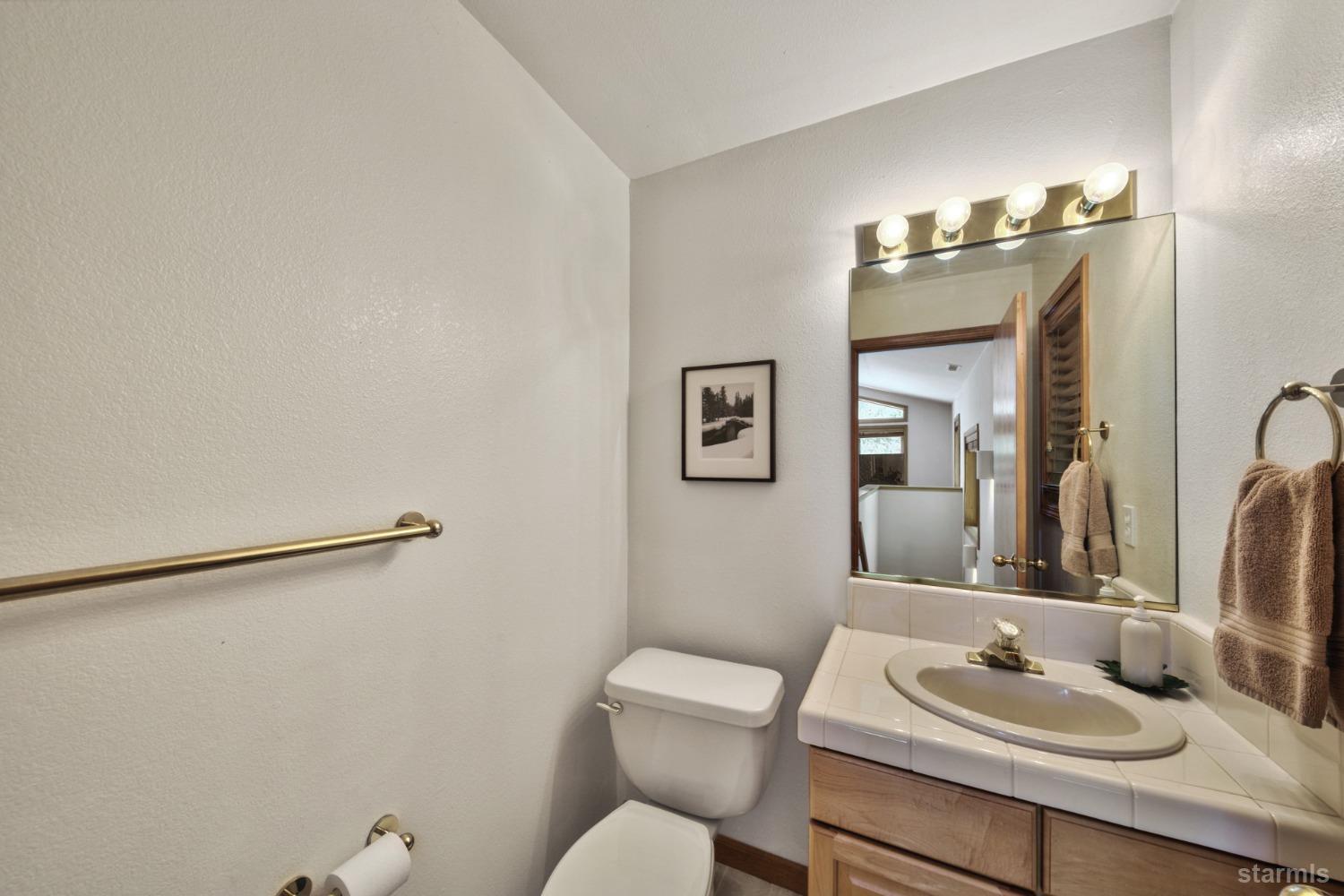 34235 Fremont Road Kirkwood, CA 95646 - Photo 21 of 29 a bathroom with a sink vanity mirror and toilet