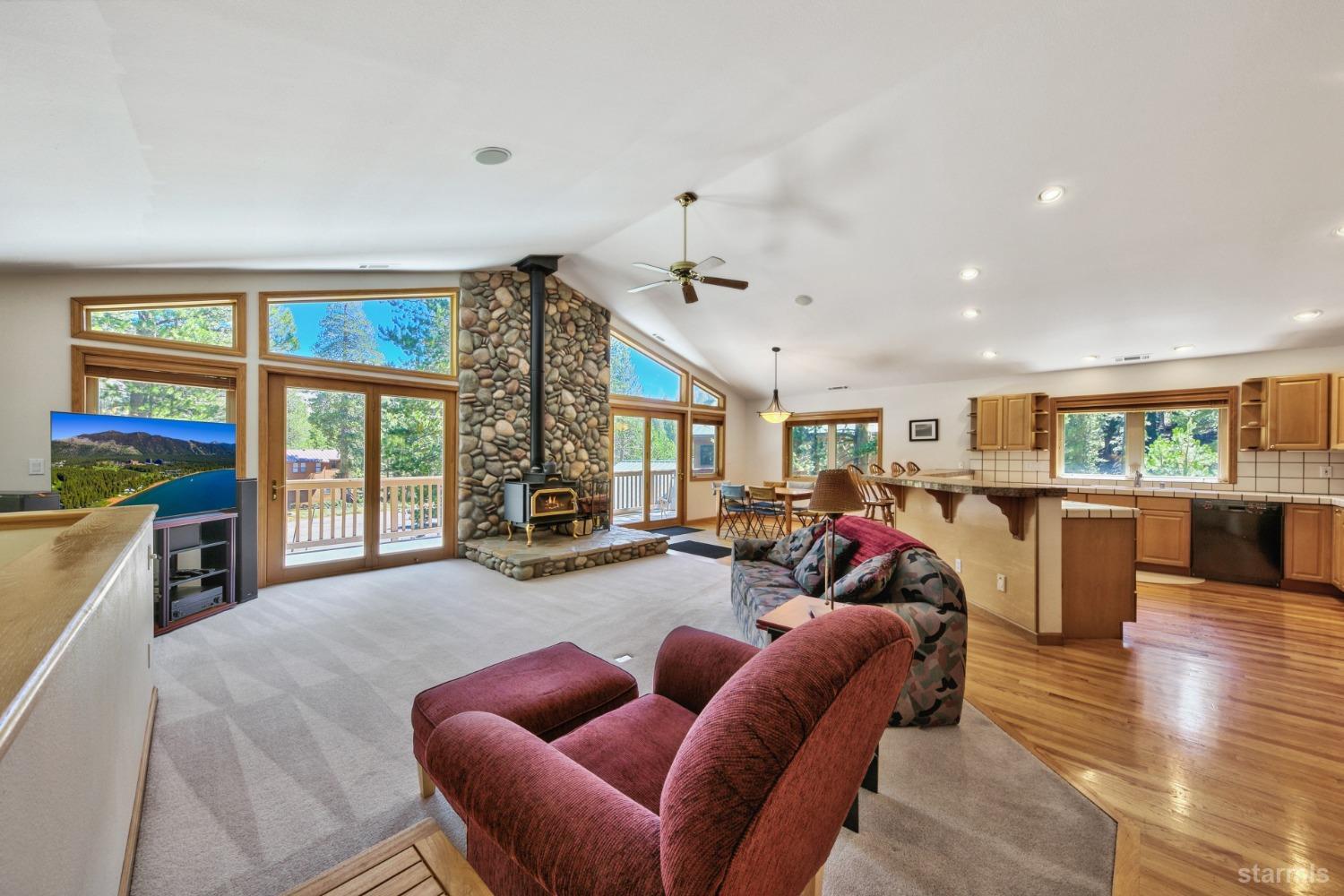 34235 Fremont Road Kirkwood, CA 95646 - Photo 4 of 29 a living room with furniture a fireplace and a floor to ceiling window