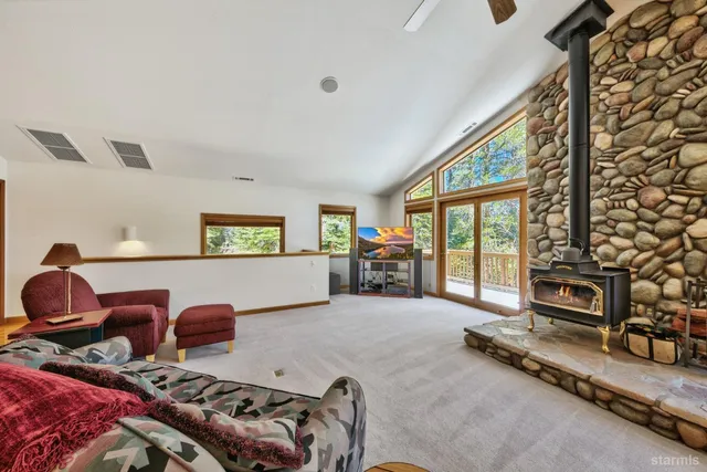 a living room with furniture gym equipment and a large window