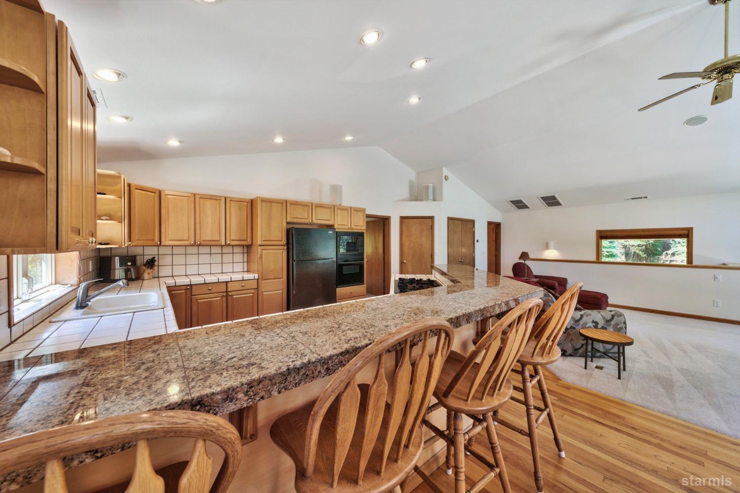 34235 Fremont Road Kirkwood, CA 95646 - Photo 10 of 29 a large kitchen with kitchen island a table and chairs in it