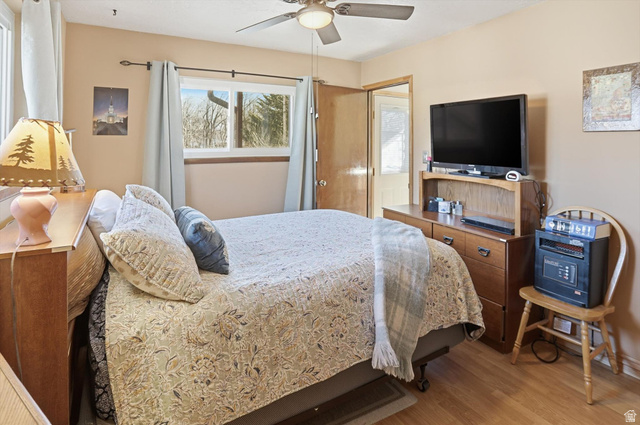 380 North 200 West Logan, UT 84321 - Photo 15 of 29 Primary bedroom featuring ceiling fan and wood finished floors