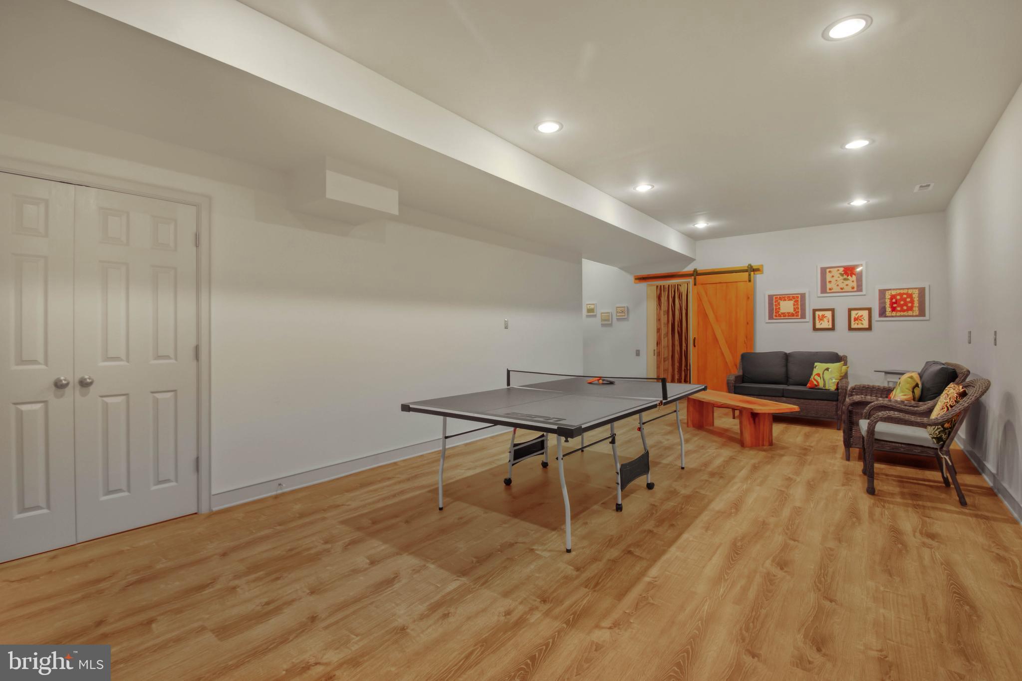 201 Biggs Purchase Lane Lothian, MD 20711 - Photo 34 of 42 a living room with furniture a table and wooden floor