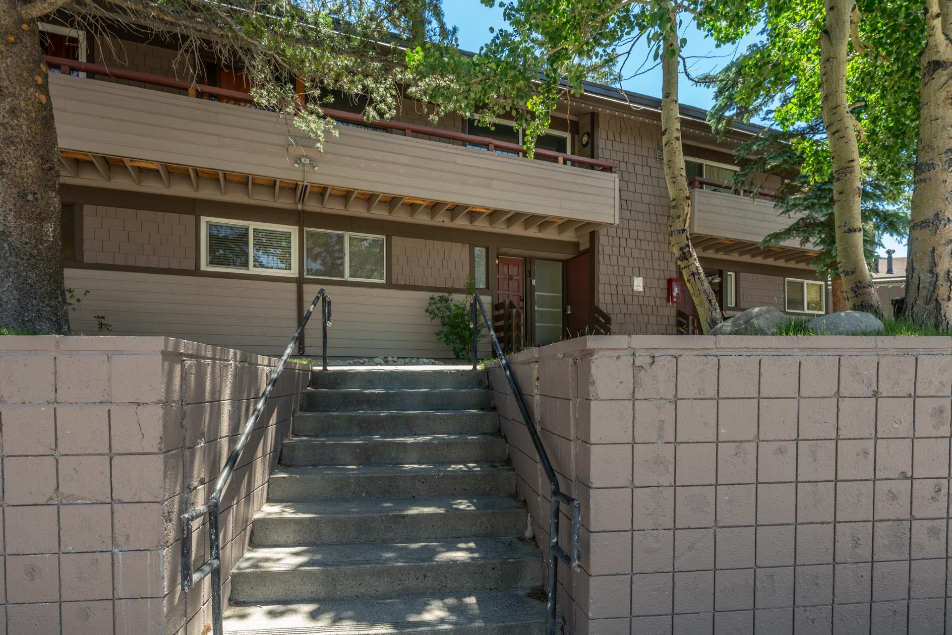 165 Old Mammoth Road, Unit 3 Mammoth Lakes, CA 93546 - Photo 42 of 48 Exterior facade featuring wood-look siding, shake shingles, and individual balconies