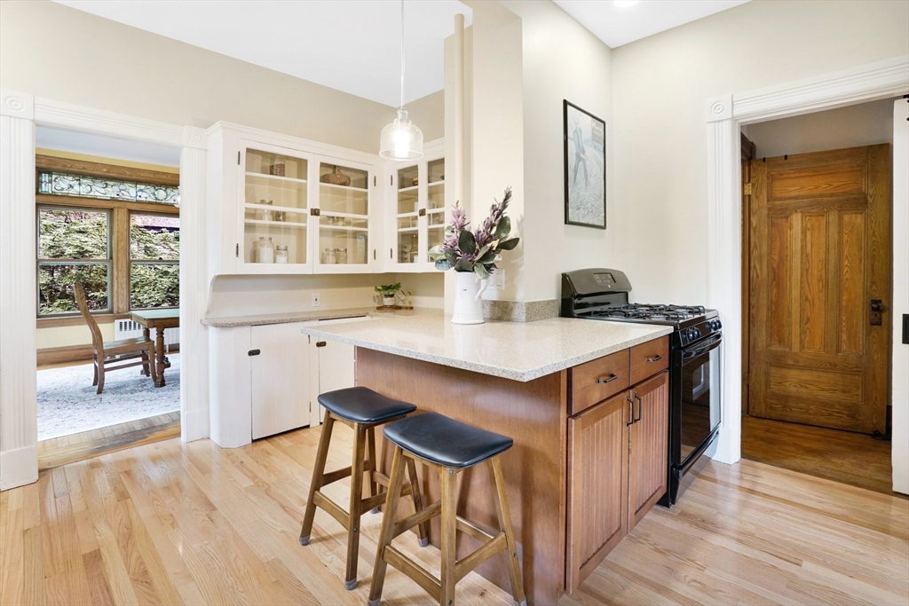 161 Longhill Street Springfield, MA 01108 - Photo 11 of 40 a kitchen with a stove a refrigerator and a dining table chair