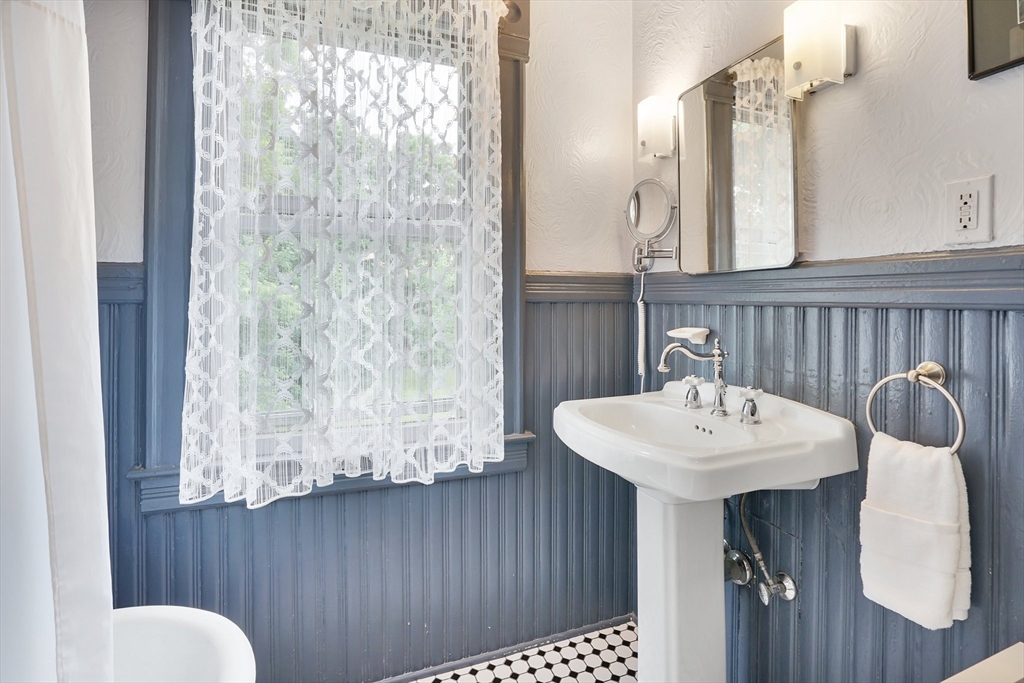 161 Longhill Street Springfield, MA 01108 - Photo 25 of 40 a bathroom with a sink a toilet and mirror