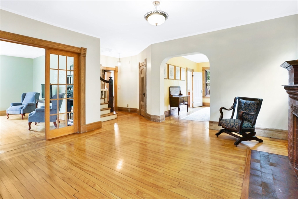 161 Longhill Street Springfield, MA 01108 - Photo 4 of 40 a view of a livingroom with wooden floor and a workspace