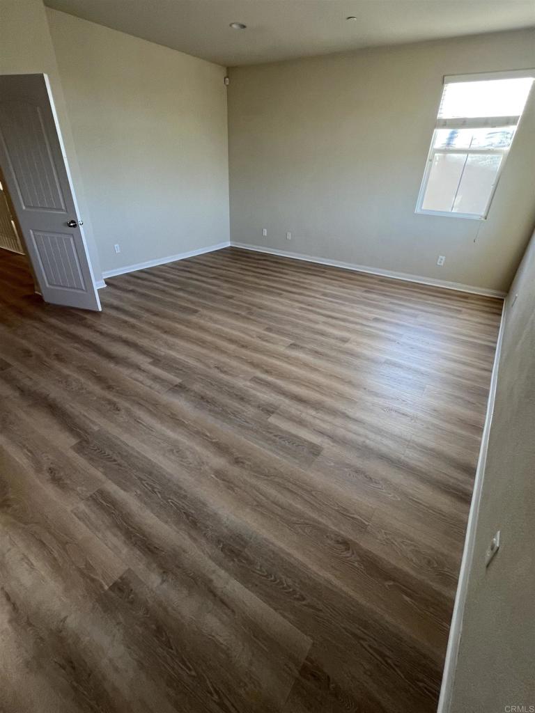 3422 Arborview Drive San Marcos, CA 92078 - Photo 11 of 21 an empty room with wooden floor and windows