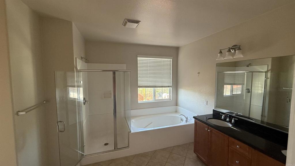 3422 Arborview Drive San Marcos, CA 92078 - Photo 13 of 21 a bathroom with a granite countertop sink a mirror and a bathtub