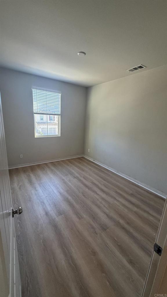 3422 Arborview Drive San Marcos, CA 92078 - Photo 15 of 21 an empty room with wooden floor and windows