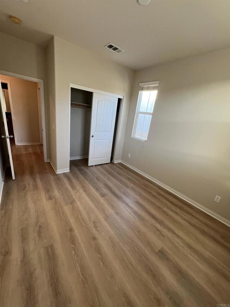 3422 Arborview Drive San Marcos, CA 92078 - Photo 16 of 21 an empty room with wooden floor and windows