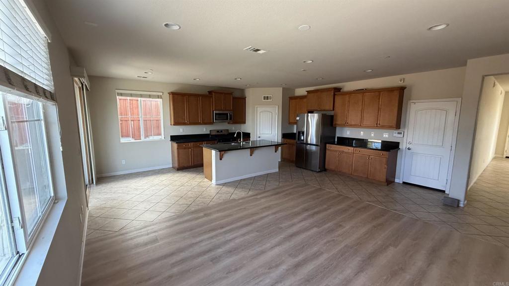 3422 Arborview Drive San Marcos, CA 92078 - Photo 4 of 21 a kitchen with stainless steel appliances granite countertop a refrigerator stove top oven and sink
