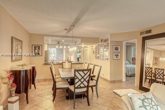 3772 Inverrary Boulevard, Unit 201 Lauderhill, FL 33319 - Photo 11 of 35 a view of a dining room with furniture and wooden floor