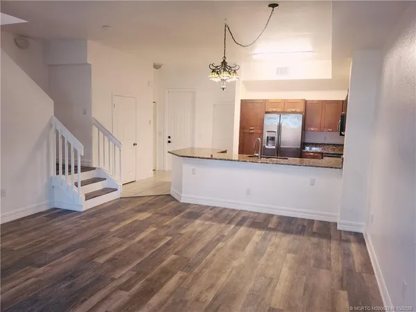 a view of a room with wooden floor and staircase