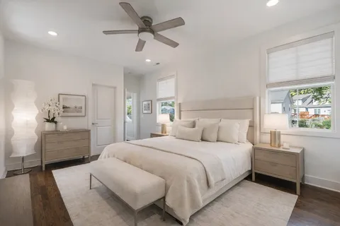 a bedroom with a large bed and a chandelier