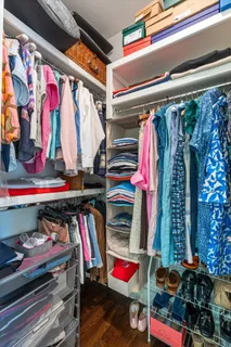 a view of walk in closet with clothes and shoes