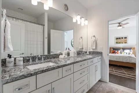 a bathroom with double sink and a mirror