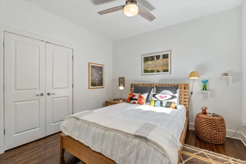 a bedroom with a bed and a table with potted plant