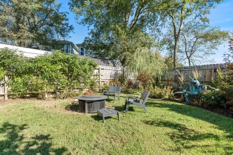 a view of a house with backyard sitting area and garden