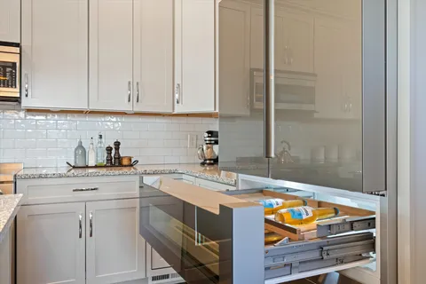 a kitchen with stainless steel appliances granite countertop a sink and cabinets