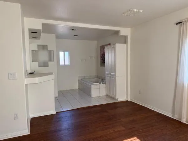 a bathroom with a granite countertop sink a toilet and a mirror