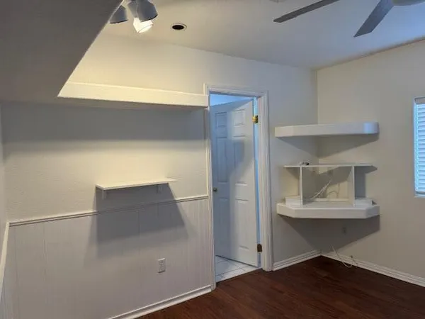 a bathroom with a granite countertop sink and a toilet