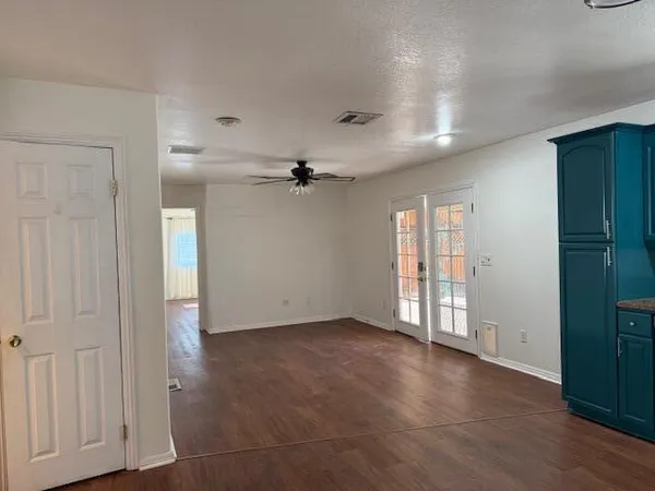 an empty room with closet area and wooden floor
