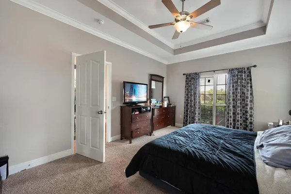 a large bedroom with a bed and a chandelier