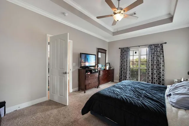 a large bedroom with a bed and a chandelier