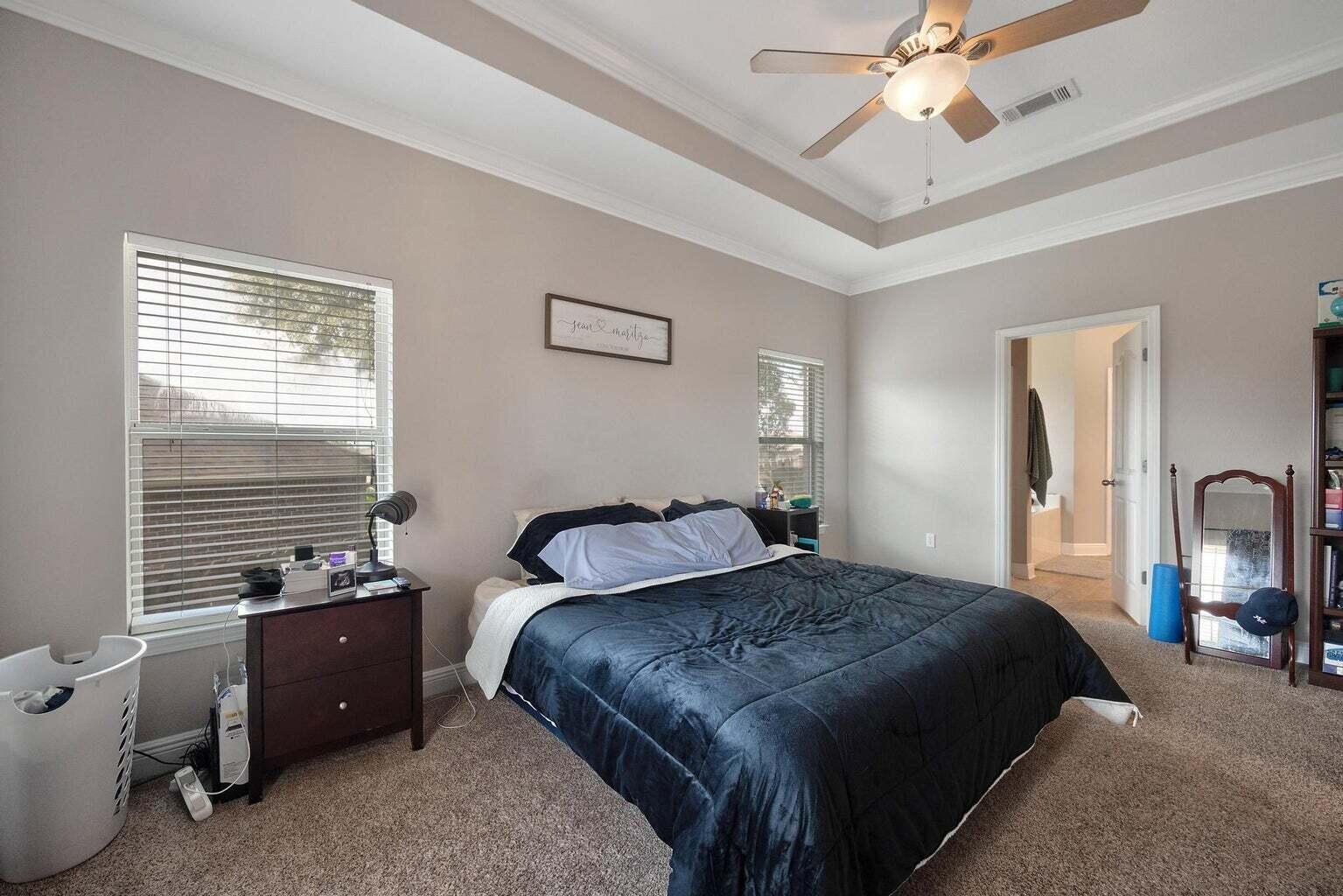 607 Rowan Circle Crestview, FL 32536 - Photo 19 of 27 a bedroom with a bed and a chandelier