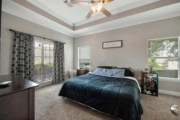 a bedroom with a bed and a window