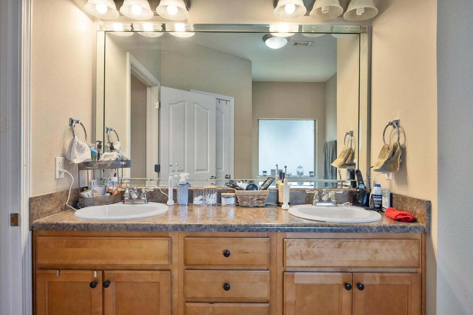 607 Rowan Circle Crestview, FL 32536 - Photo 22 of 27 a bathroom with sinks vanity and a mirror